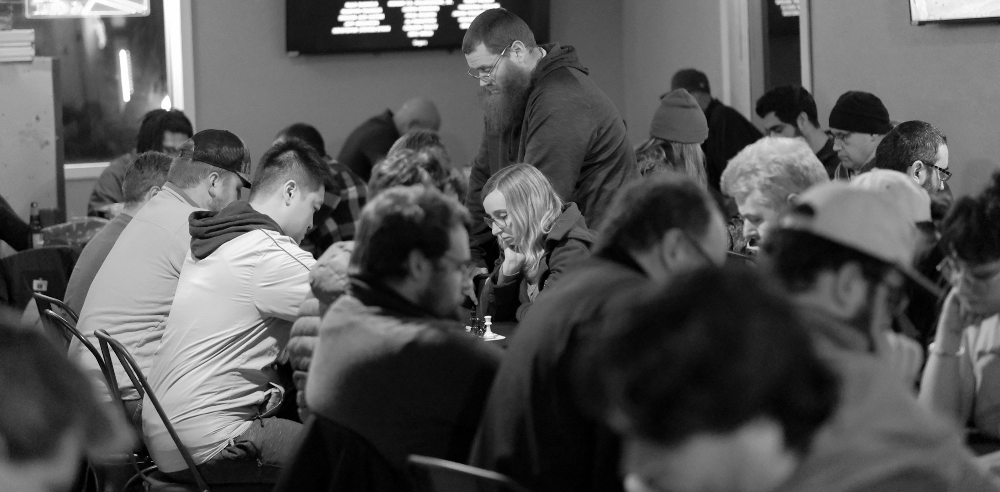 A busy Greater Lafayette Chess Club gathering with players deep in their games